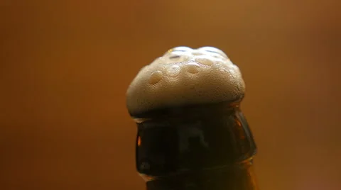 Foam flows down on a brown beer bottle (No 1.4) Stock Footage 67299417