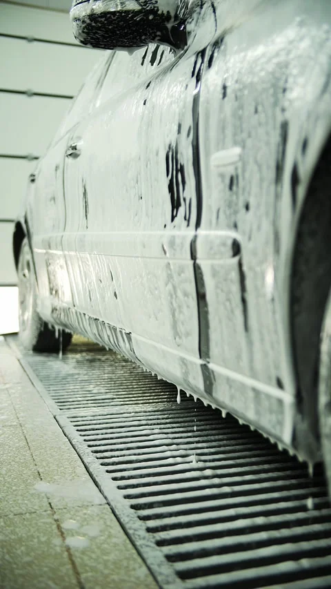 Foam flows down the car at the car wash Stock Footage 289204671