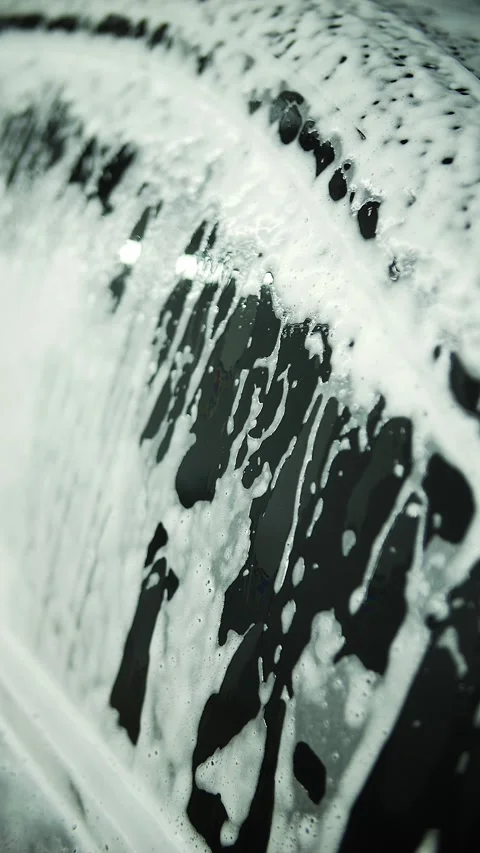 Foam flows down the car at the car wash Stock Footage 289204693