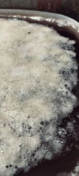 Foam that forms when black beans are left to soak in water overnight Stock Photos