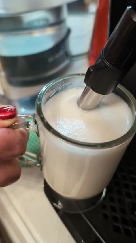 Foam frothing process using coffee machine steam wand Stock Footage 335886388