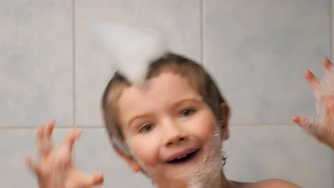 Foam on head boy making funny face close up child taking bath children portrait Stock Footage 166361929