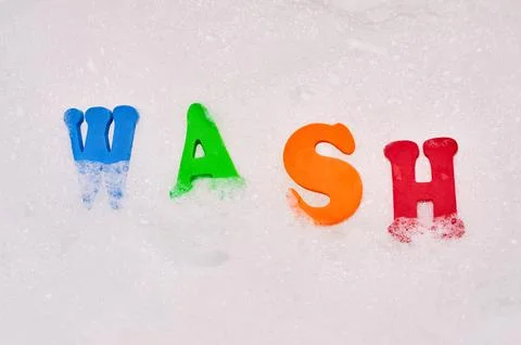 Foam letters in soap bubbles Stock Photos