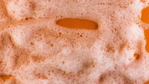 Foam on orange background macro Stock Footage 69240027