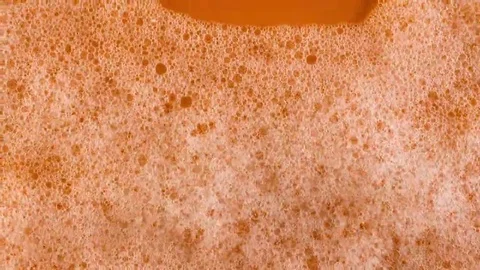 Foam on orange background macro Stock Footage 69240431