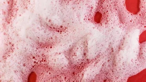 Foam on red background macro Stock Footage 69240045