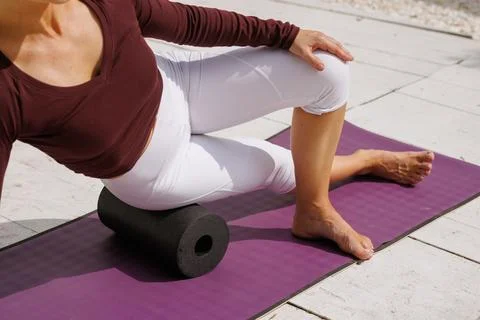 Foam roller hip and glute release for rehabilitation and pain relief outdoors Stock Photos