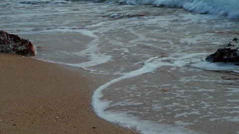 Foam Rolling Across Sandy Shoreline Stock Footage 341842033