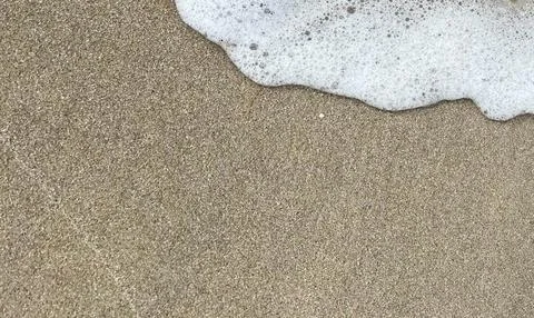 Foam on the sandy beach-01 (1) Stock Photos