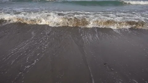 Foam sea surf on sandy beach close up, 16x 480 fps slow motion Stock Footage 86258054