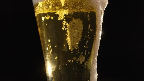 Foam slowly flows down the glass Stock Footage 297004285