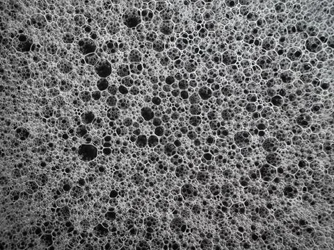 Foam sponge macro texture background, black and white porous surface close-.. Stock Photos