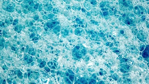 Foam on surface of liquid blue detergent, bubbles different size, rotating 動画素材 240647374