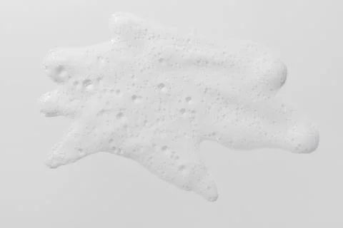 Foam swatch on white background. Soapy liquid texture with bubbles. Stock Photos