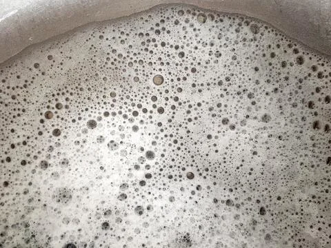 Foam texture with many bubbles of different sizes, top view Stock Photos