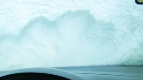 The foam is washed off the windowshield at the car wash. View from the salon Stock Footage 240565293