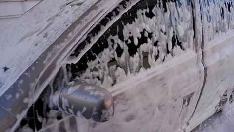 Foam for washing the car flows down the body of the car. Car wash. Stock Footage 170803621