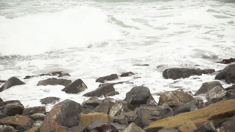 Foam wave rolls on stones slow mo Stock Footage 83211052
