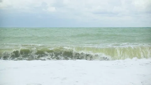 Foam from the wave on the shore and the next wave slow mo Stock Footage 82311846