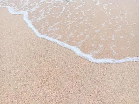 Foam waves on the beach Stock Photos