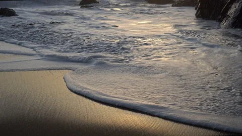 Foam from the waves close-up in the rays of the setting sun.  A bubbling foamy s Video stock 105272878