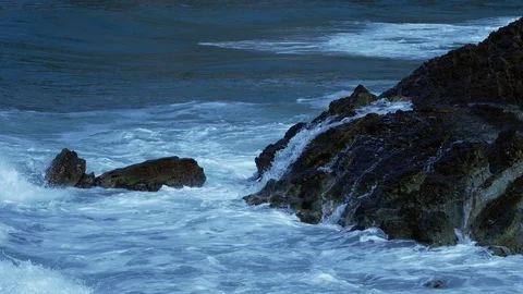 Foam of Waves Moving between black rocksTexture Backgrounds Stock Footage 89615404
