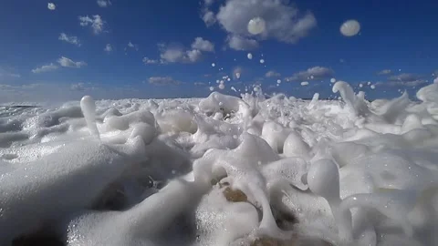Foam of waves rolling over cam Stock Footage 188440068