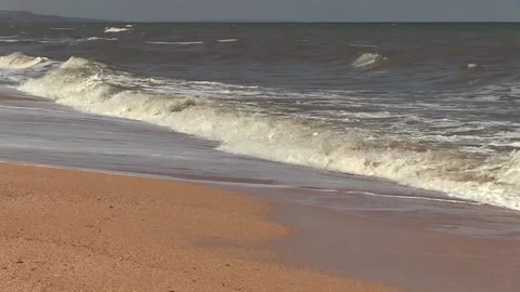 Foam waves run over the sea sand Stock Footage 145733404
