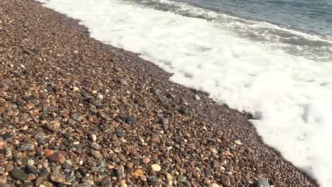 Foam waves run over the sea pebbles Stock Footage 145849716