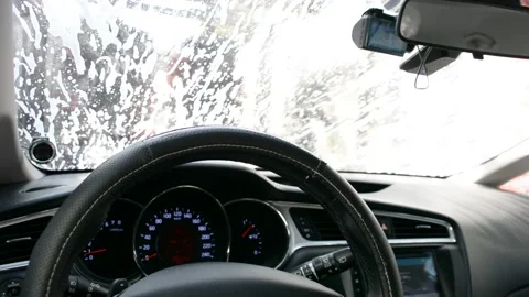 Foam on the windshield. Washing the dirt from the machine with foam. View from c Видео 161157591