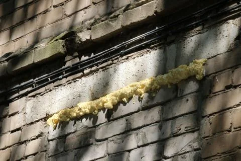 Foamed window gap of a brick wall Stock Photos
