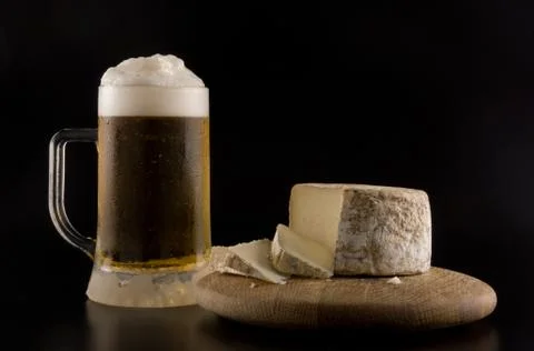 Foaming beer and cheese Stock Photos