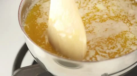 Foaming butter simmering in a pot Stock Footage 24671456