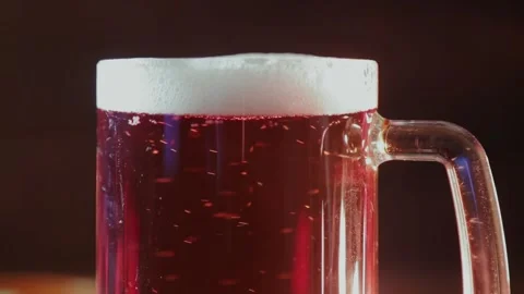 Foaming cold light beer in a glass mug Stock Footage 154372695