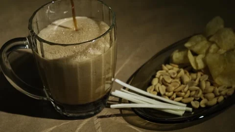Foaming dark beer and snacks, close-up. Stock Footage 260207416