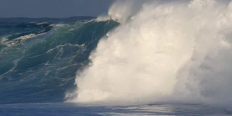 Foaming green waves rushing toward dark rocks Stock Footage 59526720