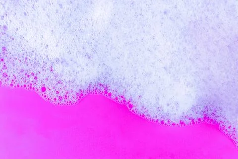 Foaming liquid on blue backdrop. Cosmetics foam background. Cosmetic produc.. Stock Photos