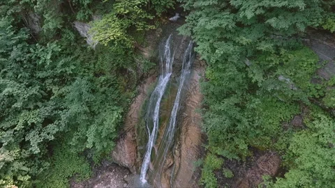 Foaming mountain waterfall water surrounded by grey wet stones with fallen l Stock-Footage 159181743