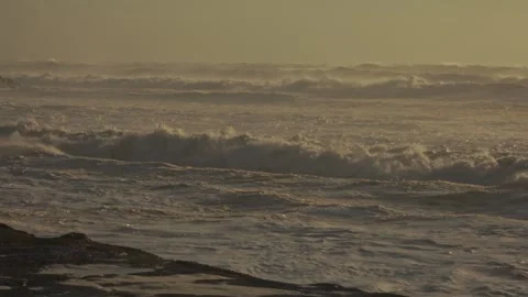 Foaming Ocean Waves Crash Onto Sandy Beach After a Storm at Sunset Stock Footage 341683962