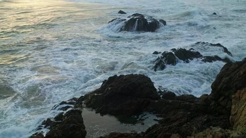 Foaming Pacific waves wash across dark rocks at Bejuco Beach, Costa Rica Stock Footage 345344291