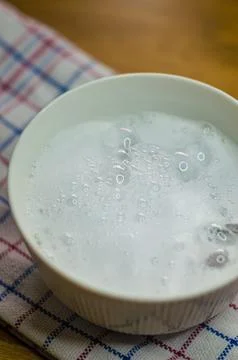 Foaming solution of baking soda, vinegar and soap to clean tough stains in bowl Stock Photos