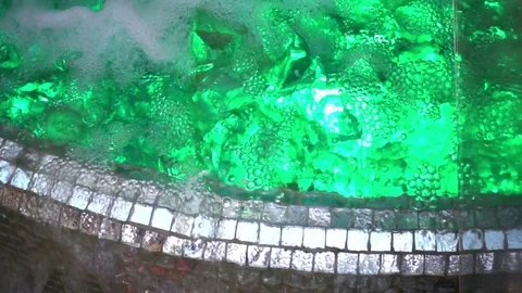 Foaming water flow in the pool with illumination in slow motion Stock Footage 82597793