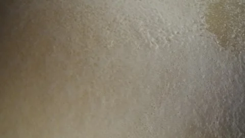 Foaming water moving over a textured sand surface 動画素材 341515359