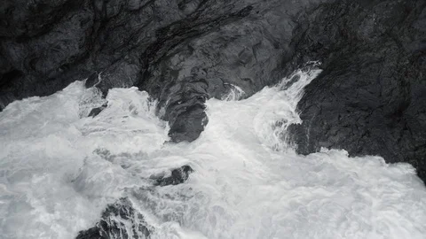 Foaming Wave Against Reef Rock in Black and White Tone Stock Footage 128947576
