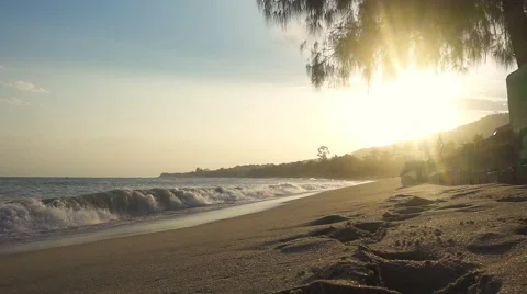 Foaming waves and shimmering sand on sunset beach. Slow motion Stock Footage 58743470