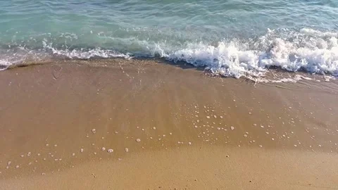 Foaming waves breaking on the sandy beach Stock Footage 250629398