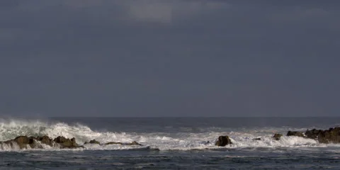 Foaming waves exploding above a rocky reef Stock Footage 59525306