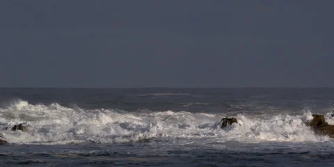 Foaming waves exploding across the frame above a rocky reef Stock Footage 59525349