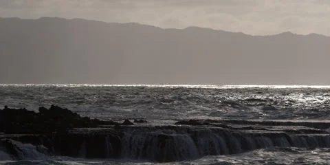 Foaming waves exploding close to the camera on a rocky reef Stock Footage 59525061