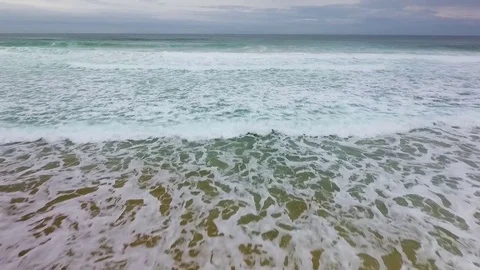 Foaming waves roll to the coast of the Atlantic Ocean Stock Footage 76839771